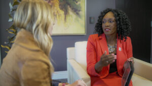 vanessa Mathews speaking with employee Asfalis Advisors